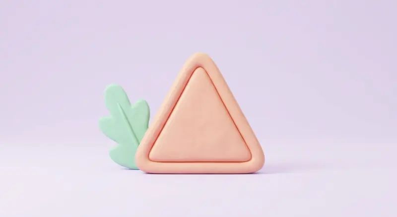 Triangle d'avertissement pastel à côté d'une feuille