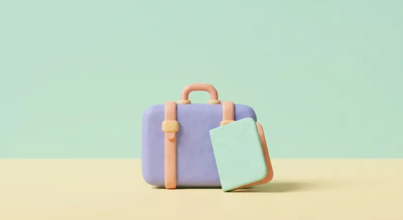 Petite valise pastel et carnet fermé